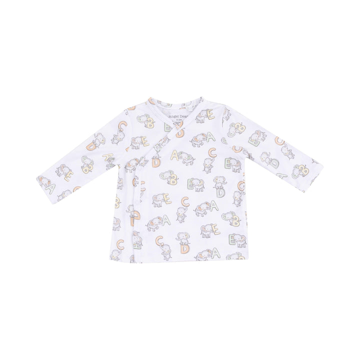 close up of the white top with elephants and SBC print on it. 