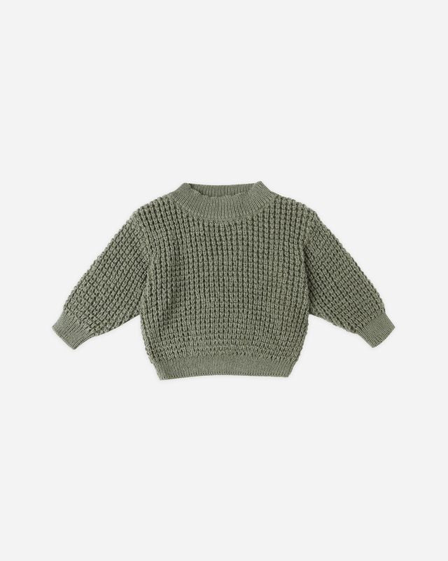 Green knitted sweater on a white background