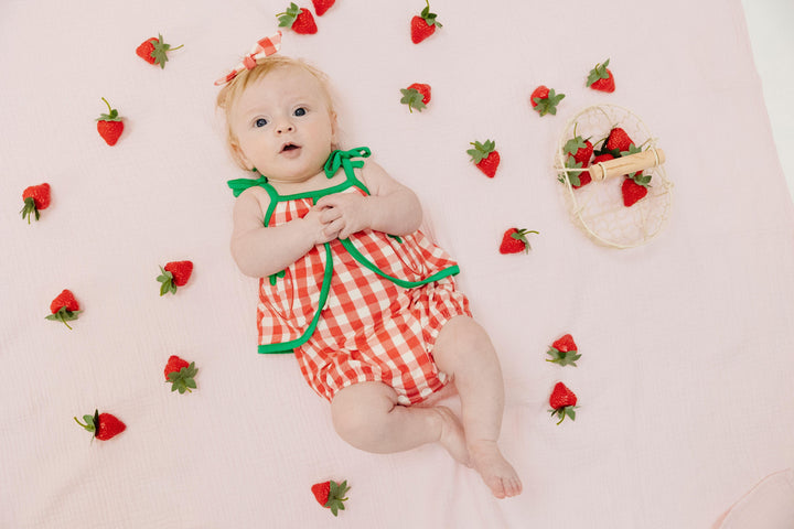 baby modeling the red and white gingham sunsuit. has a nice roomy fit and snaps at the bottom