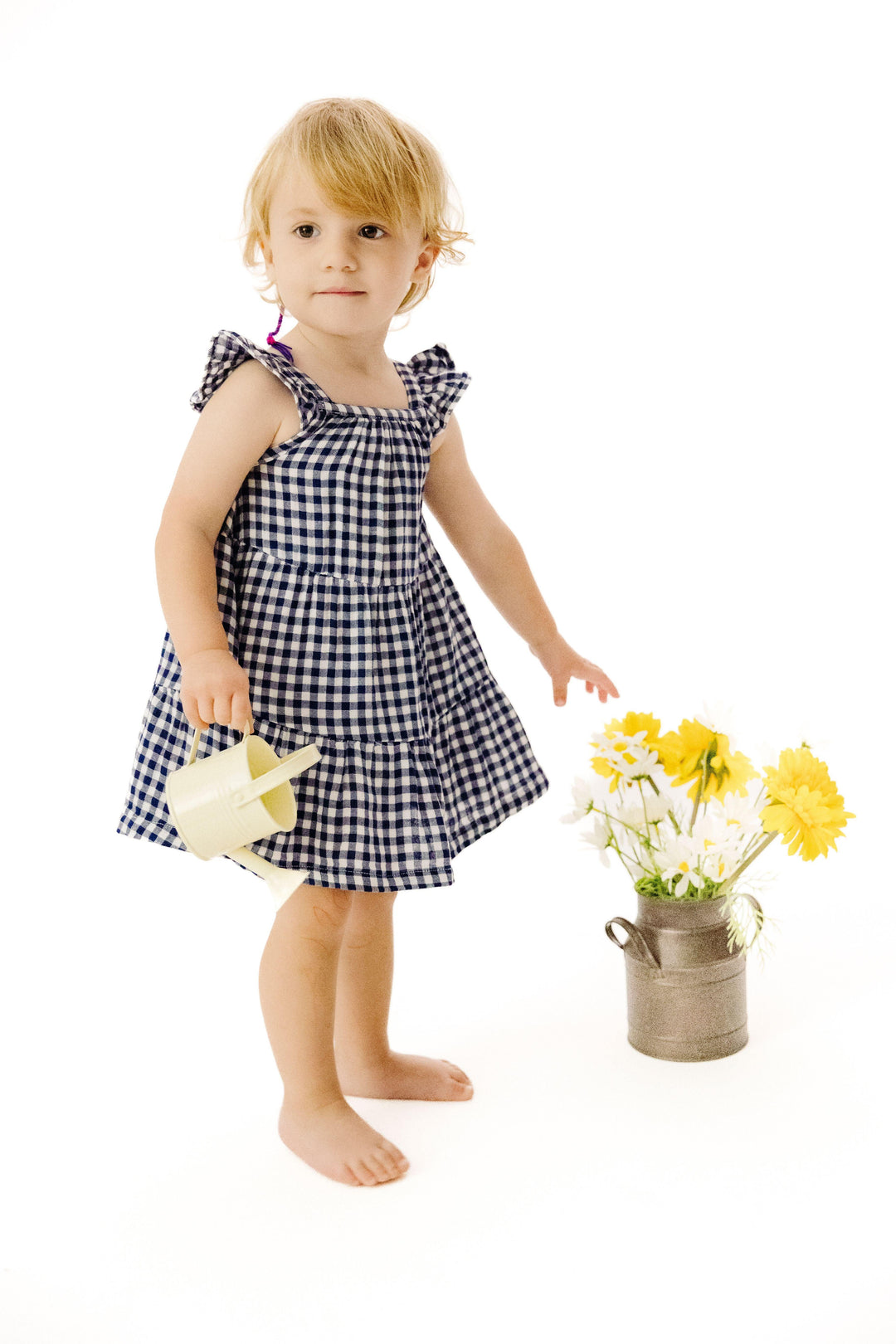 baby modeling the navy gingham dress. lots of movement for twirling and ruffle at the sleeve. 