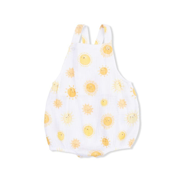 White baby romper with yellow sun patterns on a white background