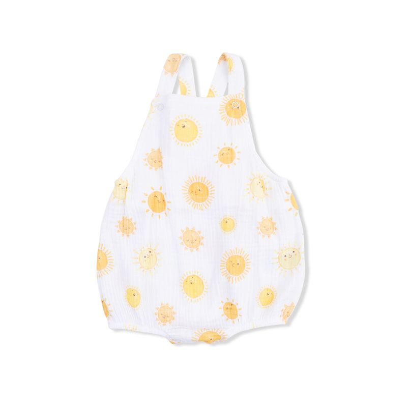 White baby romper with yellow sun patterns on a white background