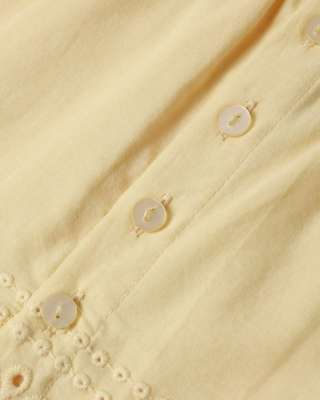 Close-up of a yellow fabric with button details
