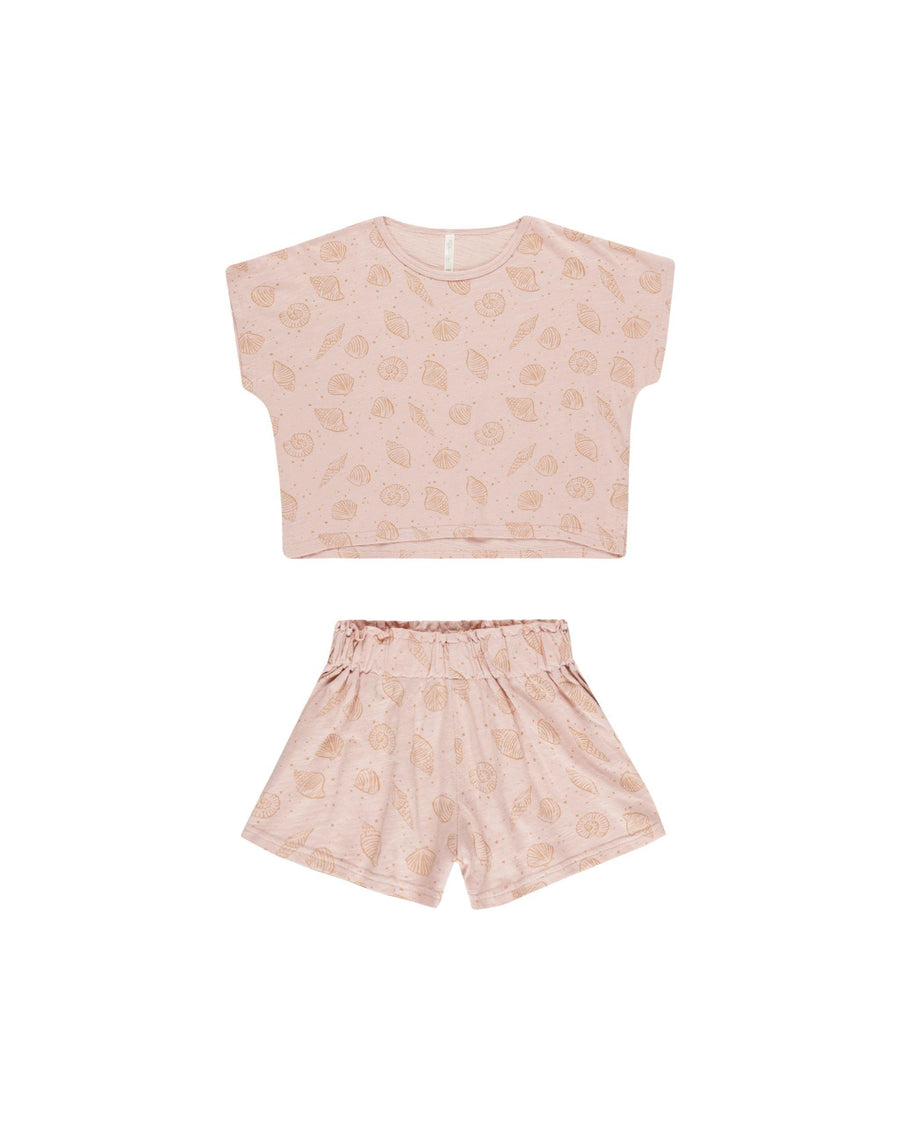 pink two piece girls set with short sleeves, shorts and a seashell print. 