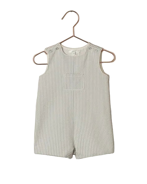 Striped romper on a hanger against a beige background