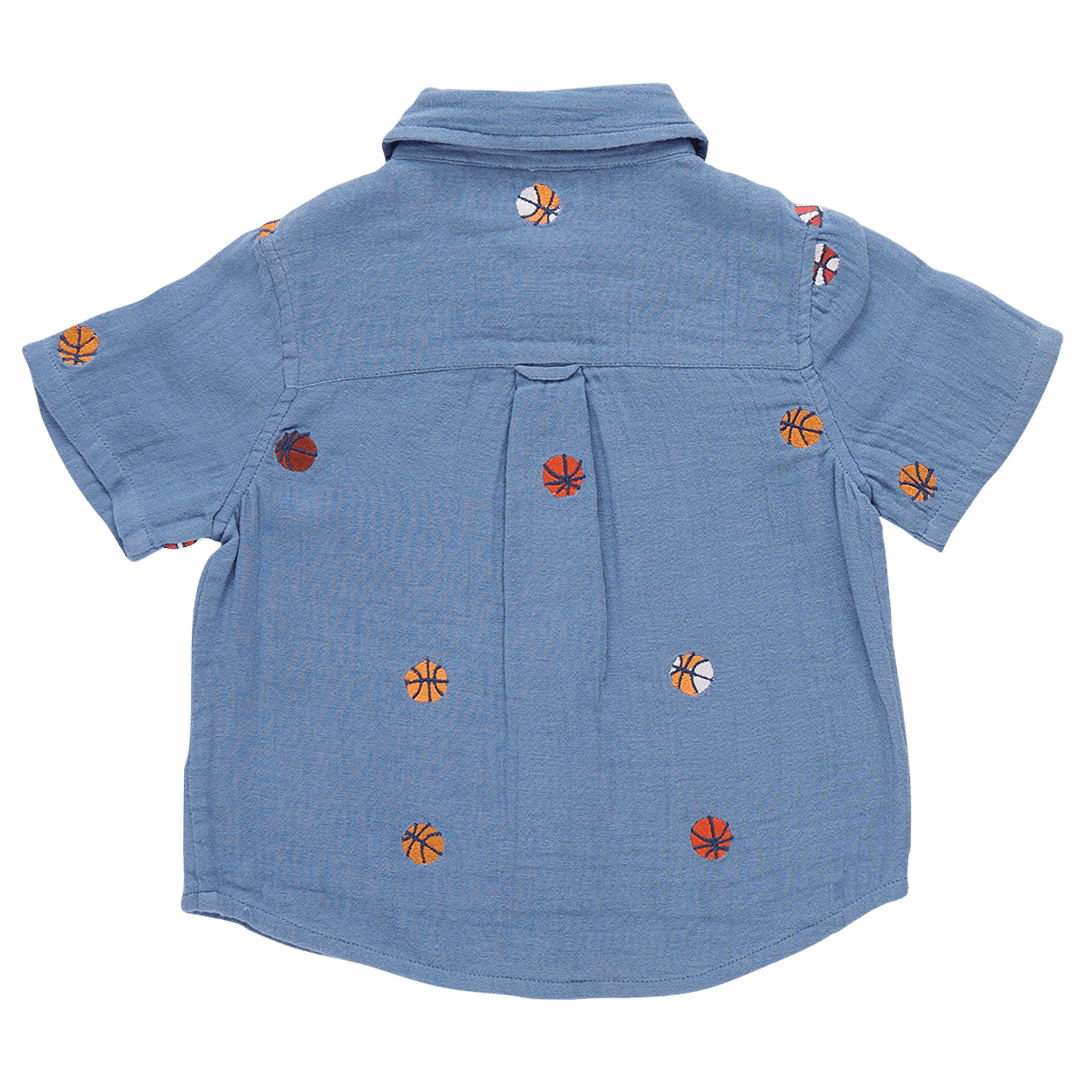 blue collared shirt with basketballs embroidered all over it. slight pleat in the back. 