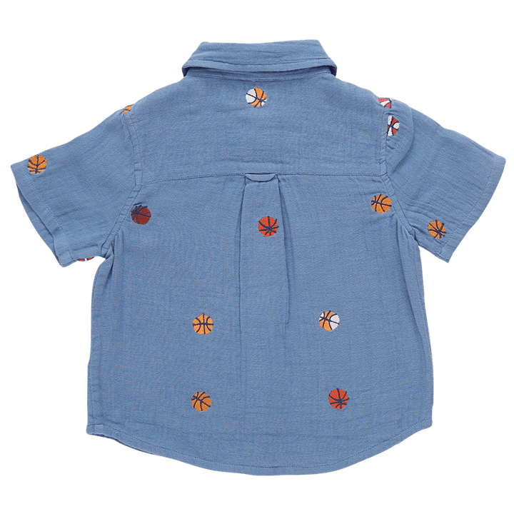 blue collared shirt with basketballs embroidered all over it. slight pleat in the back. 