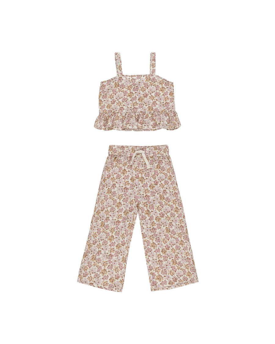 two piece set, sleeveless top with ruffle at the bottom and matching pants with drawstring. widlflower print: warm pinks, beige and brown florals 