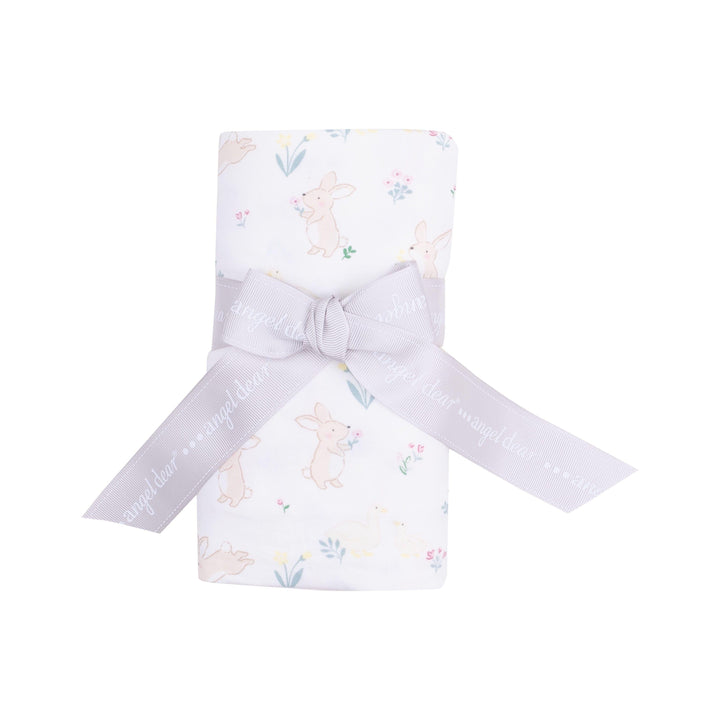 this picture shows the swaddle rolled up with white background and has tiny bunnies and chicks and tiny flowers all over. 