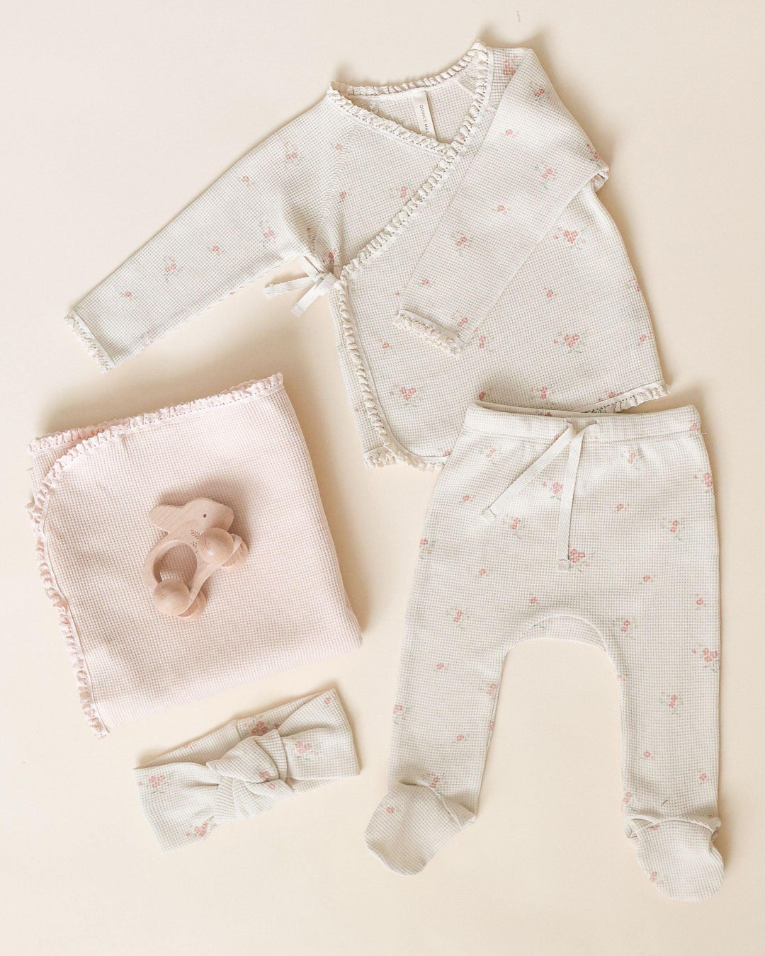 take home set beige waffle set with tiny pink rosebuds all over. set is pictured with a blanket and matching headband