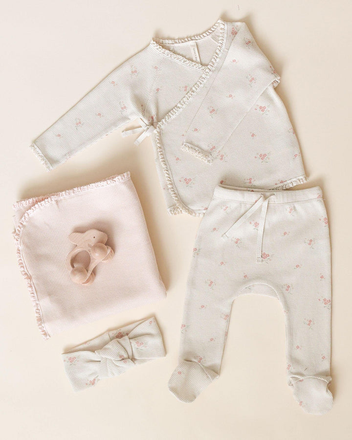 take home set beige waffle set with tiny pink rosebuds all over. set is pictured with a blanket and matching headband