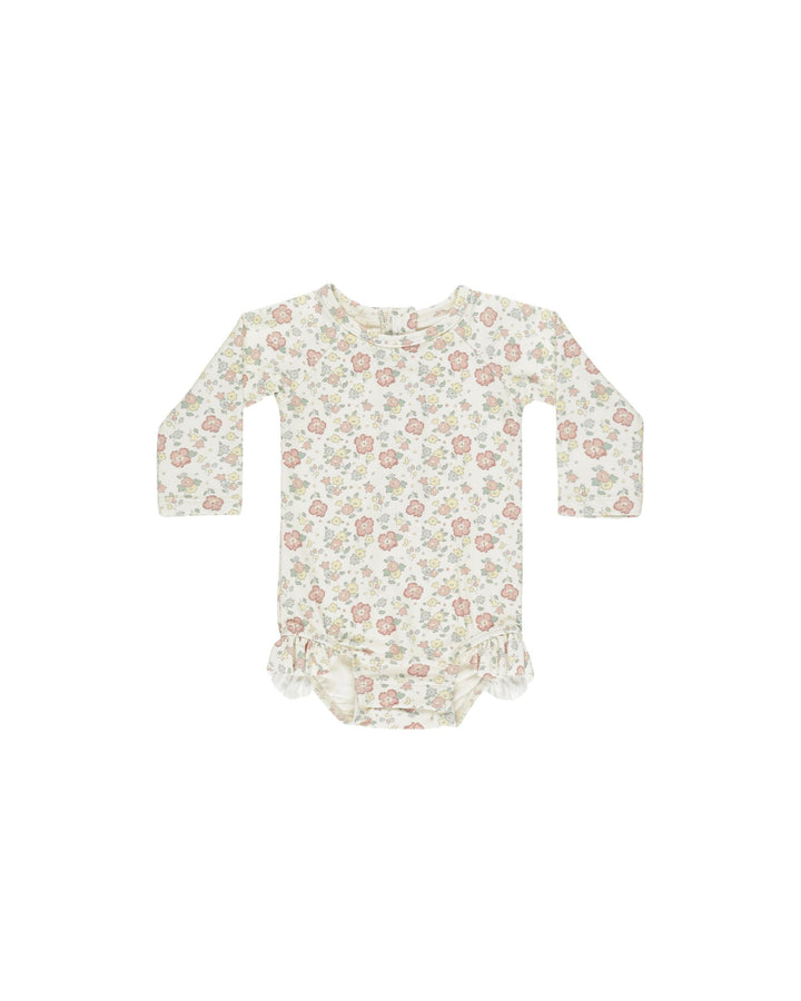baby girl rashguard bathing suit, long sleeve in pastel floral print. tiny ruffle at the leg opening. 