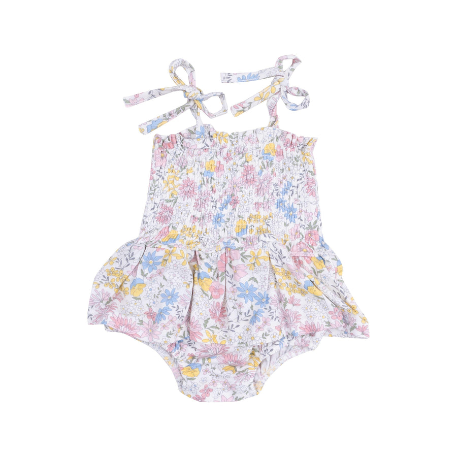 smocked bubble with peplum skirt and ties at the shoulder. snaps at the bottom for diaper changes. pastel floral pattern all over. 