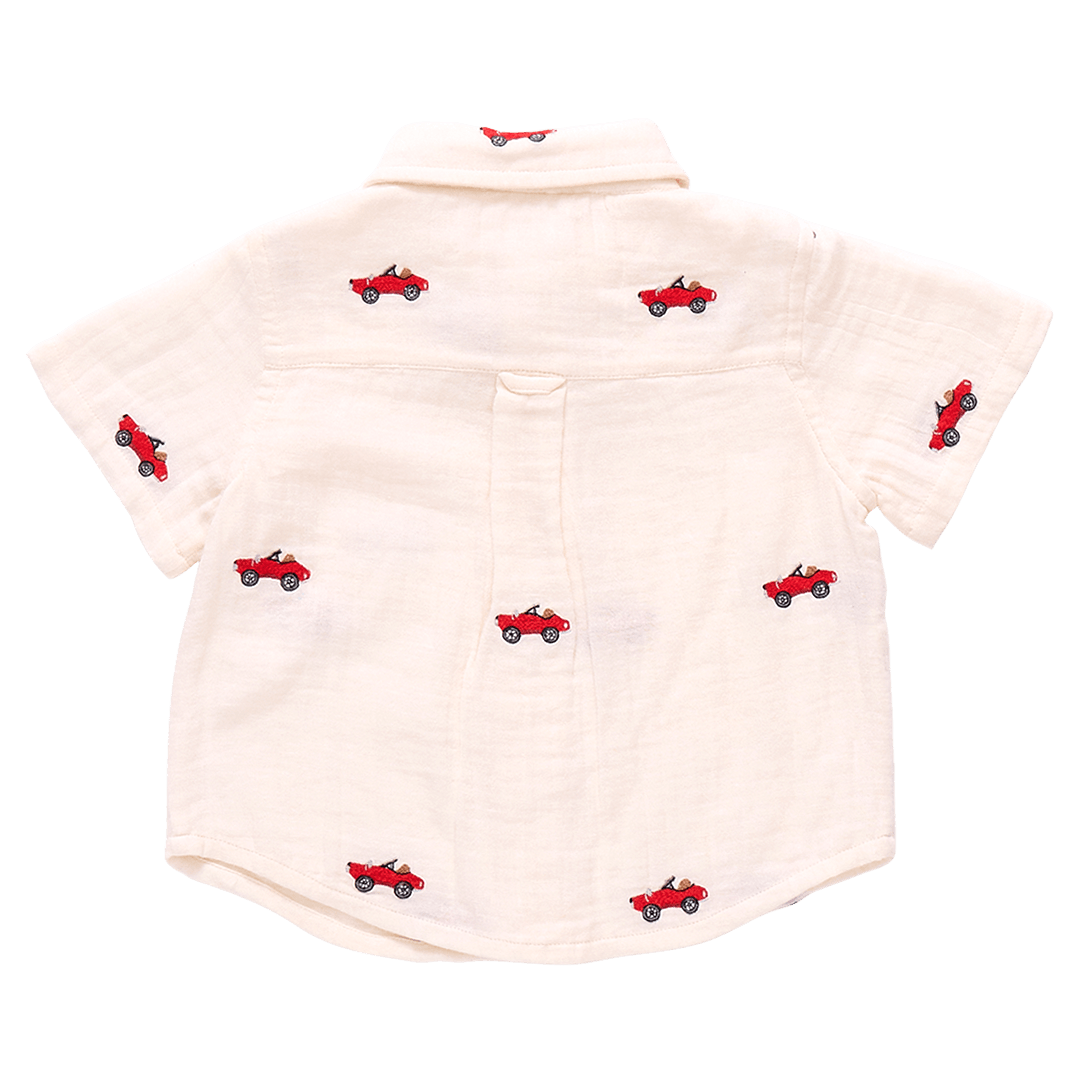 this picture shows the back of the ivory gauze shirt with embroidered cars