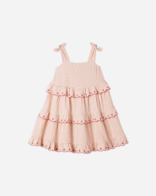 Pink checkered dress with ruffled layers on a white background