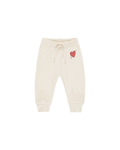 beige sweatpants with burgindy heart on the top left corner