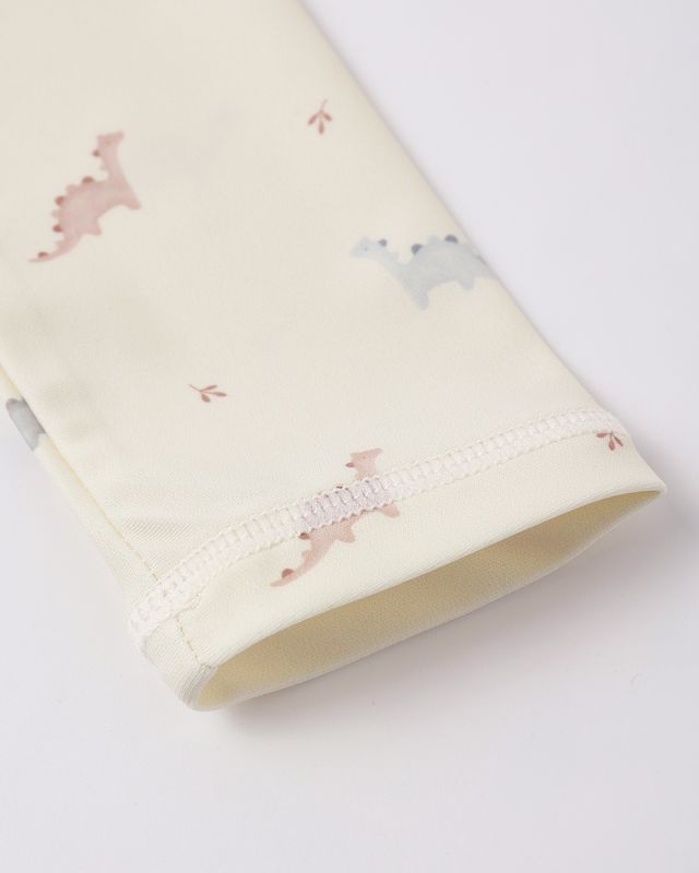 sleeve of a baby rashguardblanket with dinosaur pattern on a white background