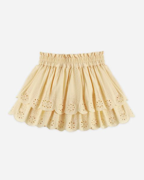 Yellow skirt with floral cut-out details on a white background