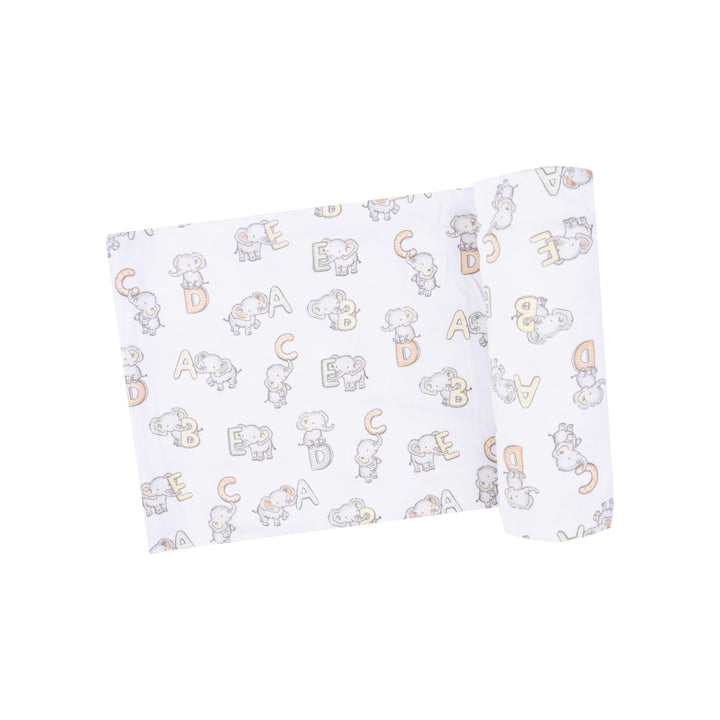 white baby swaddle/receiving blanket with elephants and ABC print all over