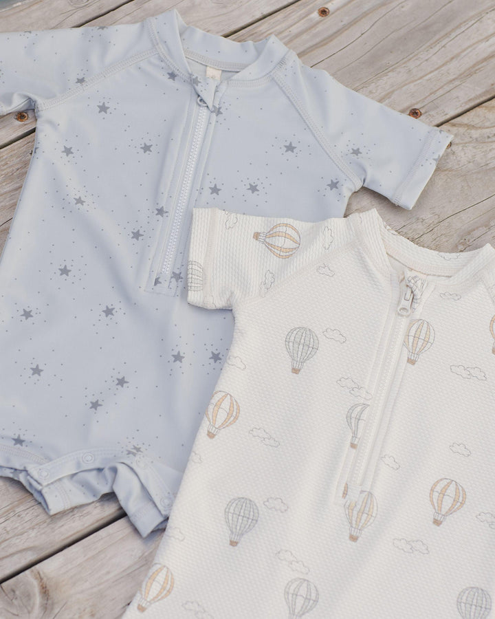 picture of hot iar balloon and star printed rashguard. each with zipper at the top and snaps at the bottom. 