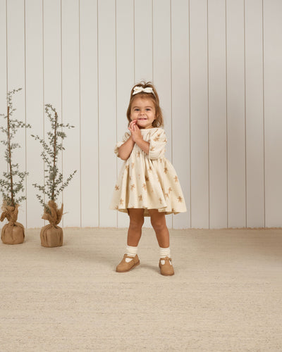 little girl modeling the gingerbread dress. sleeves to the elbow and hits at the knee. 