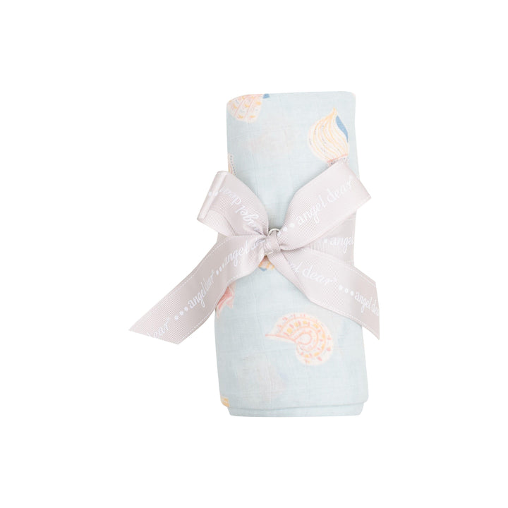swaddle tied and rolled with a ribbon, light blue with shells in a peach/beige color. this is how it looks when the swaddle is sold to a customer. 
