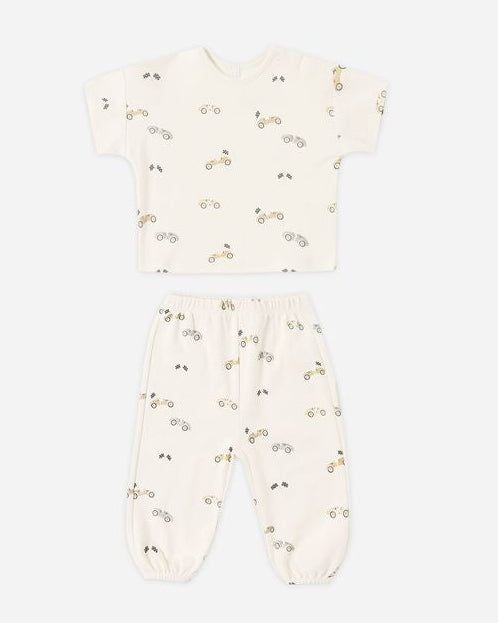 Baby 2 piece outfit with race car pattern on a white background