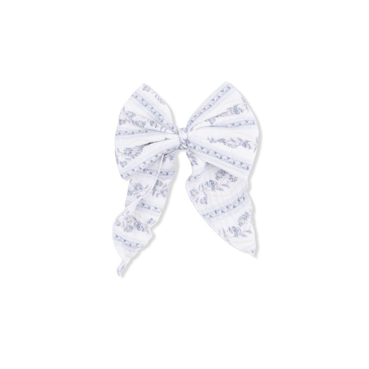 Large white bow with blue floral pattern on a white background