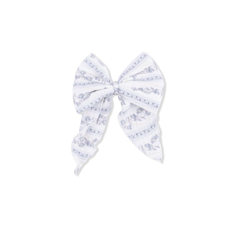 Large white bow with blue floral pattern on a white background