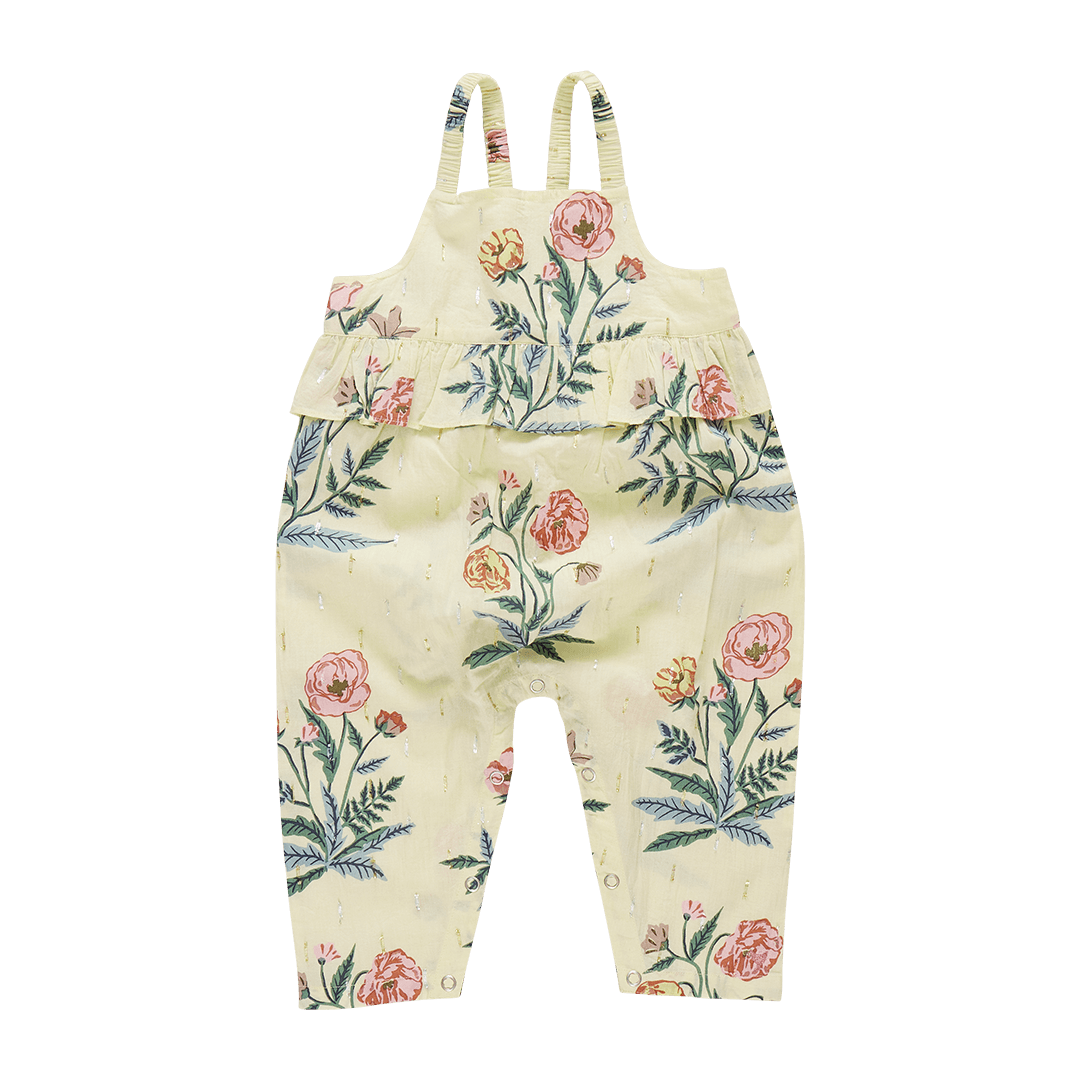 pale yellow jumpsuit with pale pink and yellow jlowers on it. gold lurex on the jumpsuit as well