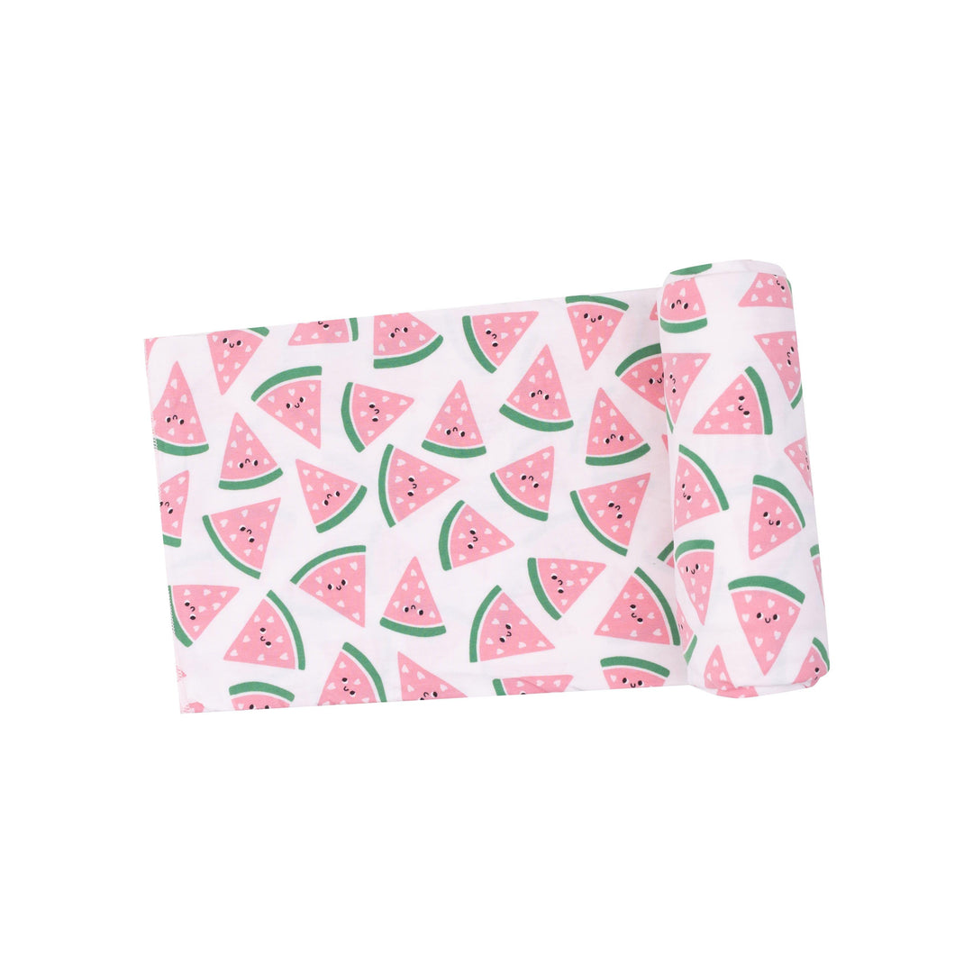 baby swaddle with tiny watermelon pieces with hearts and smiley faces on the watermelon