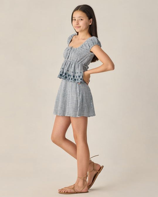 girl wearng marine gingham top and flowy skirt