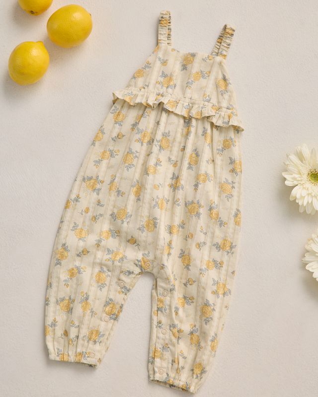 Baby romper with yellow floral pattern on a light background