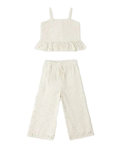 White lace top and pants set on a white background
