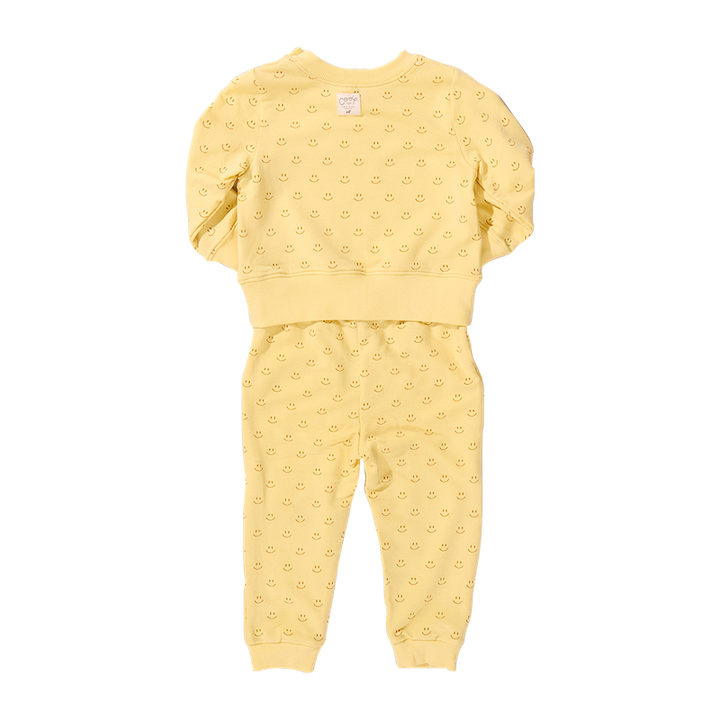 Yellow smiley baby outfit with ruffled sleeves on a white background
