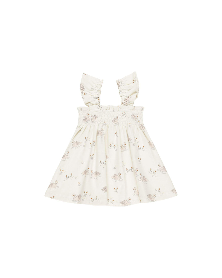 baby dress with smocked top and gathered sleeves. Swans printed all over the dress. 