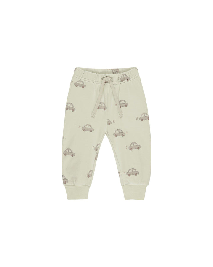 pistachio colored sweatpants with drawstring, car printed all over them. 