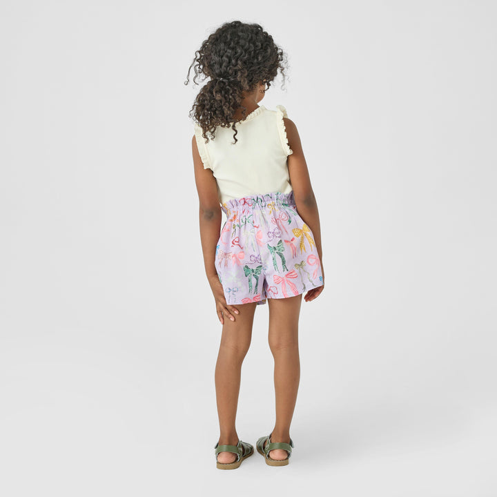 little girl modeling the lavender shorts with different color bows and a cream tank 