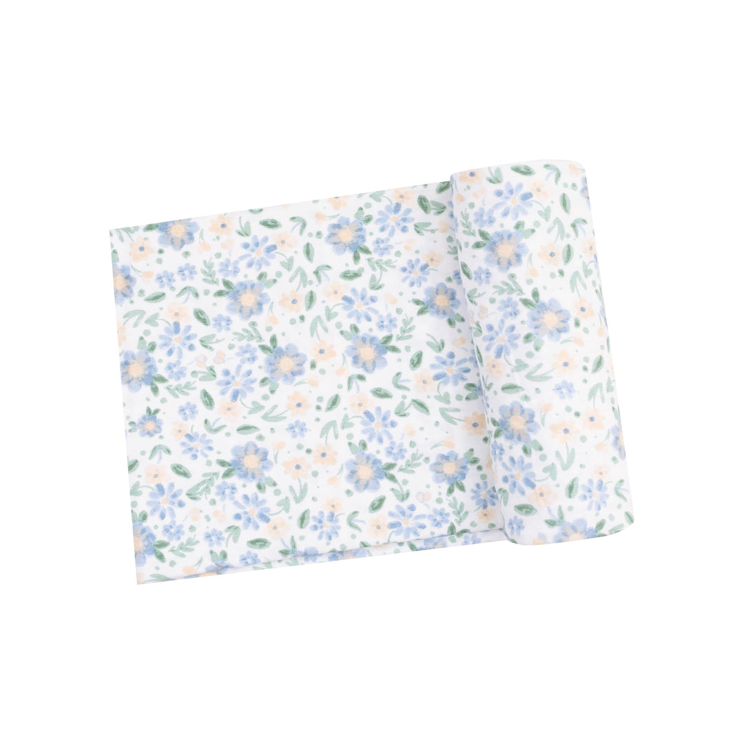 baby swaddle with delicate blue and peach floral print. 