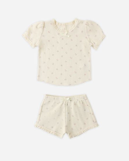 Beige top and shorts set with small rose patterns on a white background