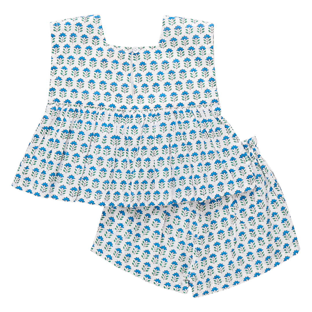 girls set with top and shorts, white with blue flowers and tiny green stems. button closure at the top and elastic waist shorts. 