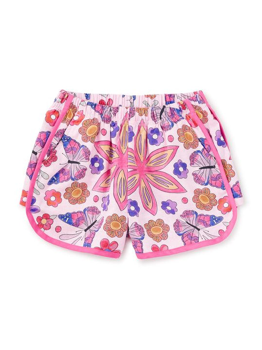 Colorful floral and butterfly patterned shorts on a white background