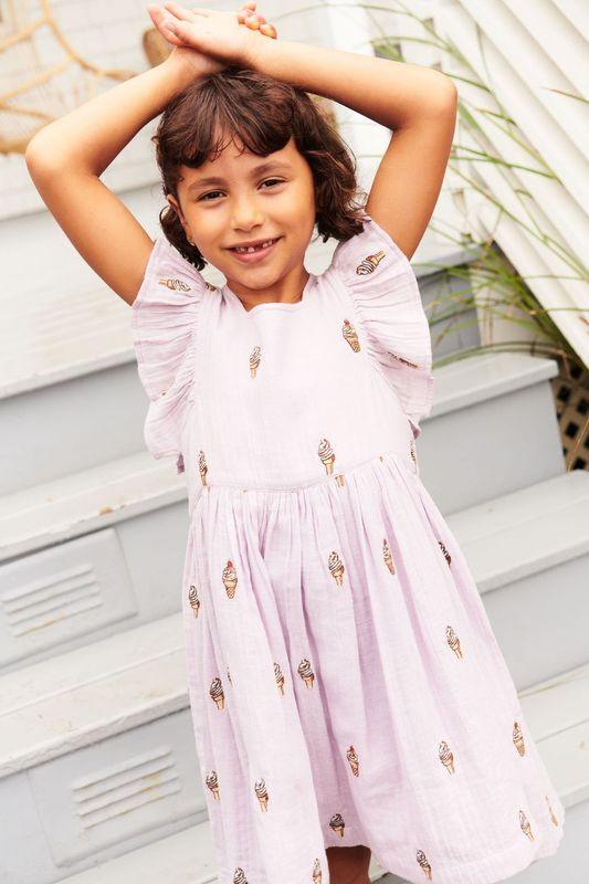 this is a close up photo of the way the dress falls on the little girl and how large the ruffles are on the sleeve