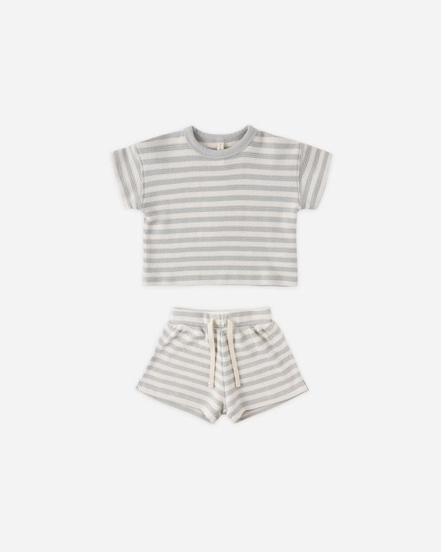 Striped t-shirt and shorts set on a white background