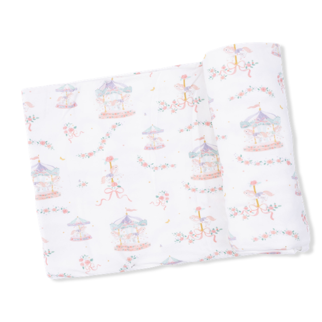 Folded fabric with a pattern of colorful carousels on a white background