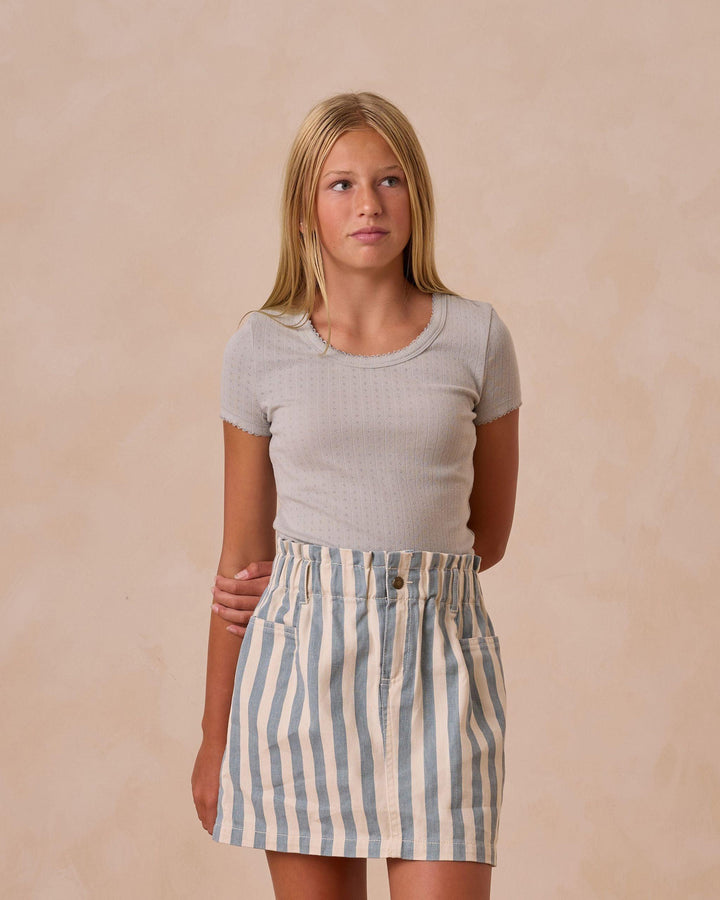 young girl modeling the blue and natural striped denim skirt. elastic waist/paperbag style skirt. 