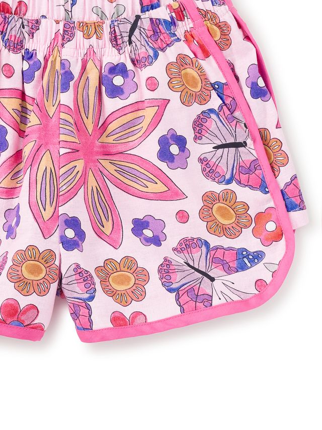 Children's shorts with colorful butterfly and flower pattern on a white background