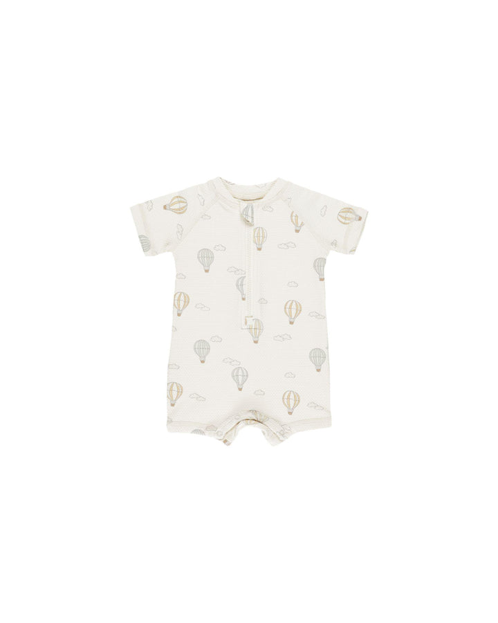 baby boy rashguard with zipper at the top, short sleeves and snaps at the bottom. hot air balloon print all over. 