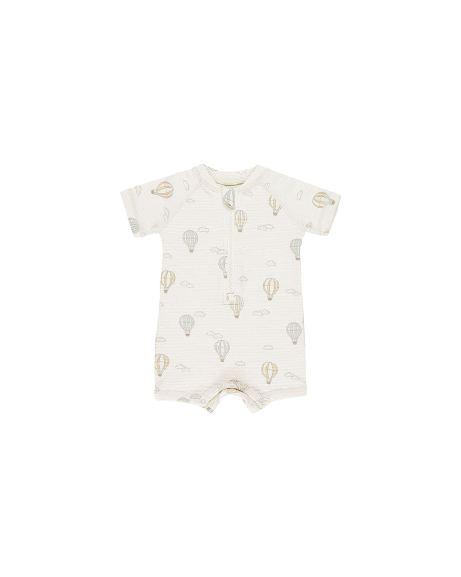 baby boy rashguard with zipper at the top, short sleeves and snaps at the bottom. hot air balloon print all over. 