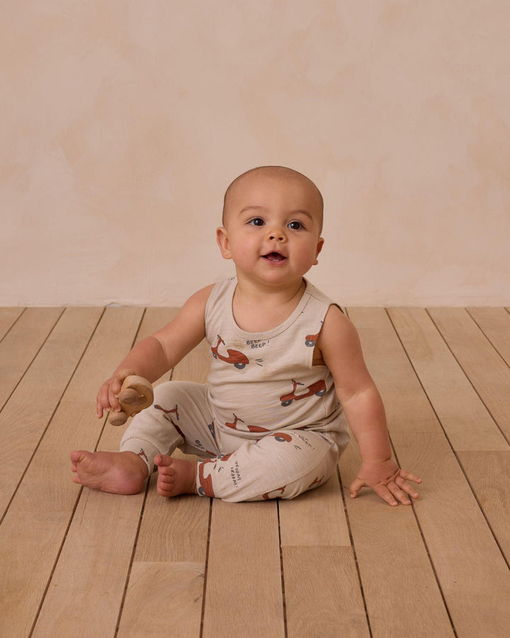 baby sitting on the floor wearing the moped 2 piece set 
